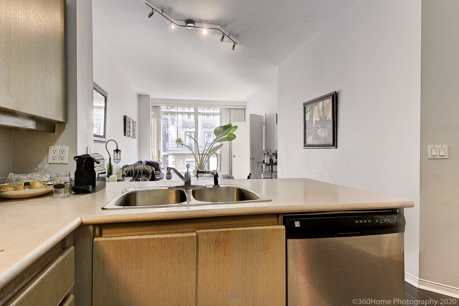 Close up of 7 King St E #817 kitchen counters, cabinets and sink.