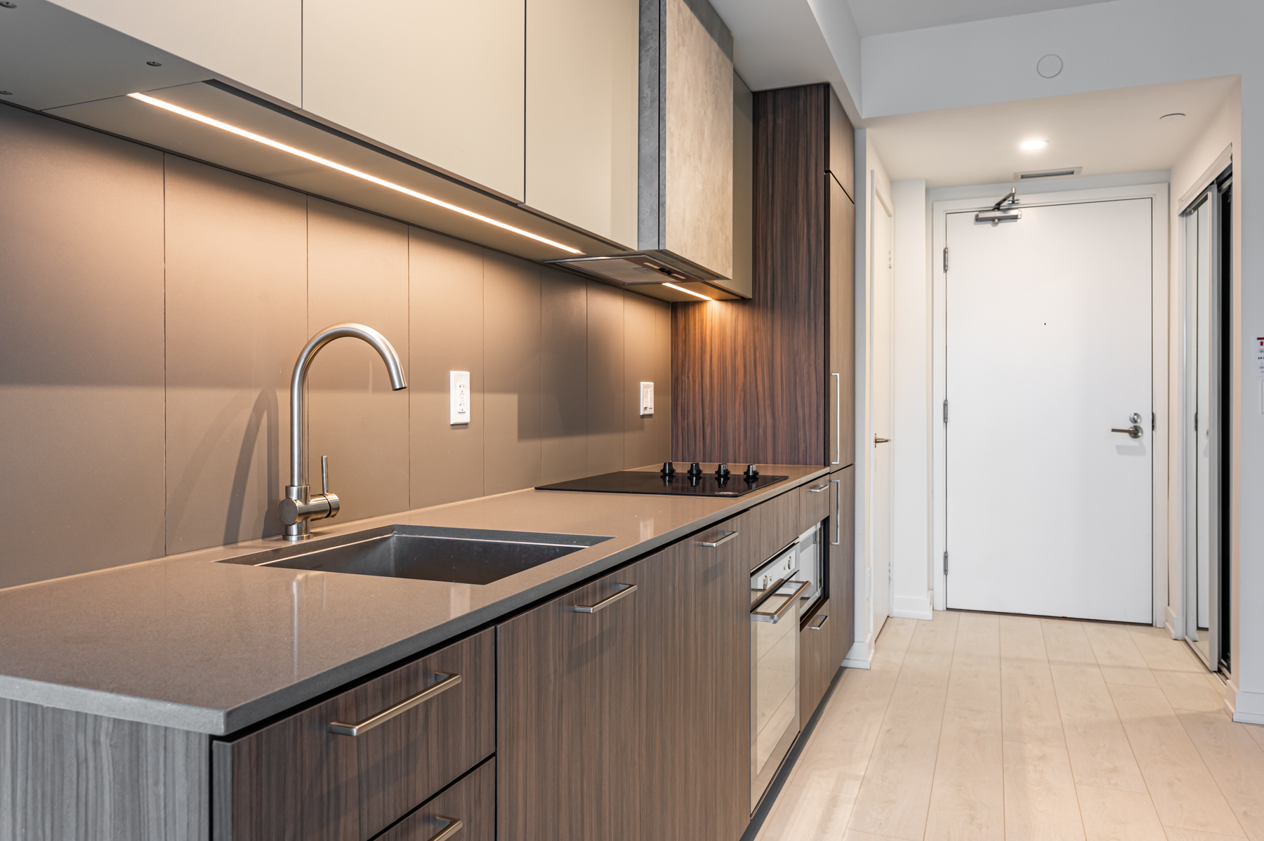 Kitchen with strip of under-cabinet lighting.