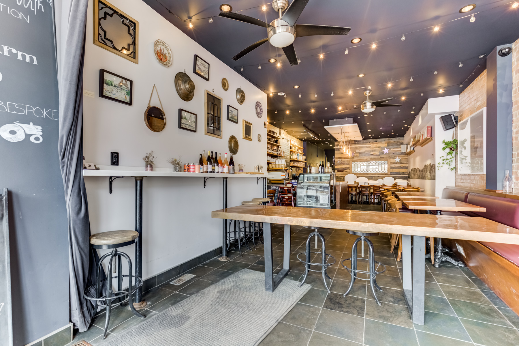 463 Danforth Ave restaurant with ceiling fan, strings of lights and wall accessories.