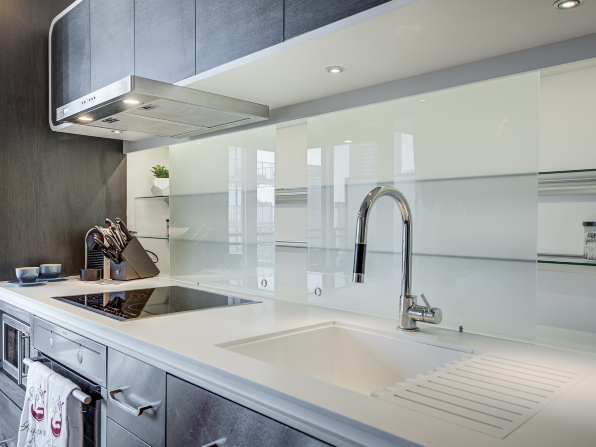Frosted back-splash with sliding doors containing hidden glass shelves.