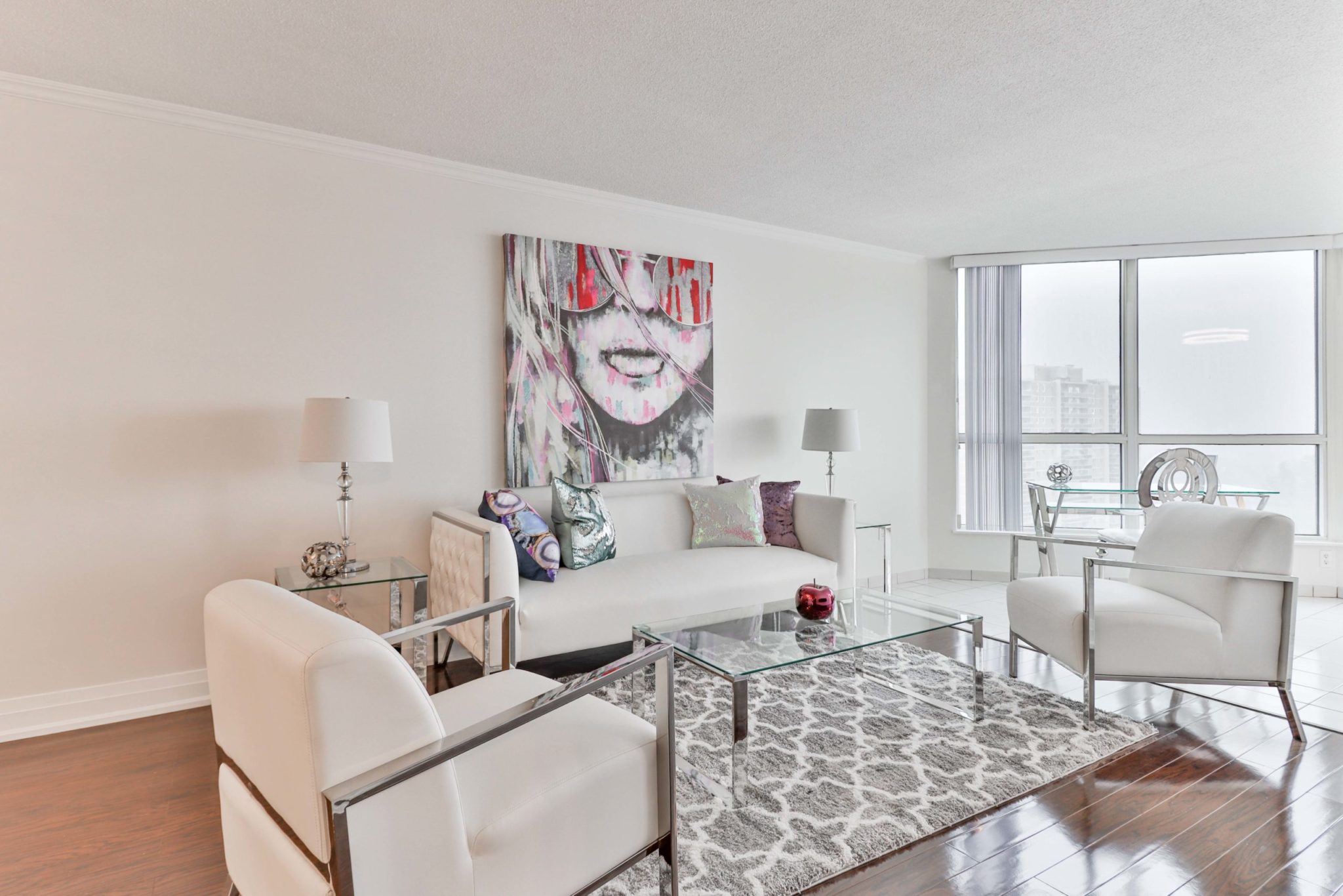 Living room of 5 Rowntree Rd with modern furniture, décor and shiny laminate floors.