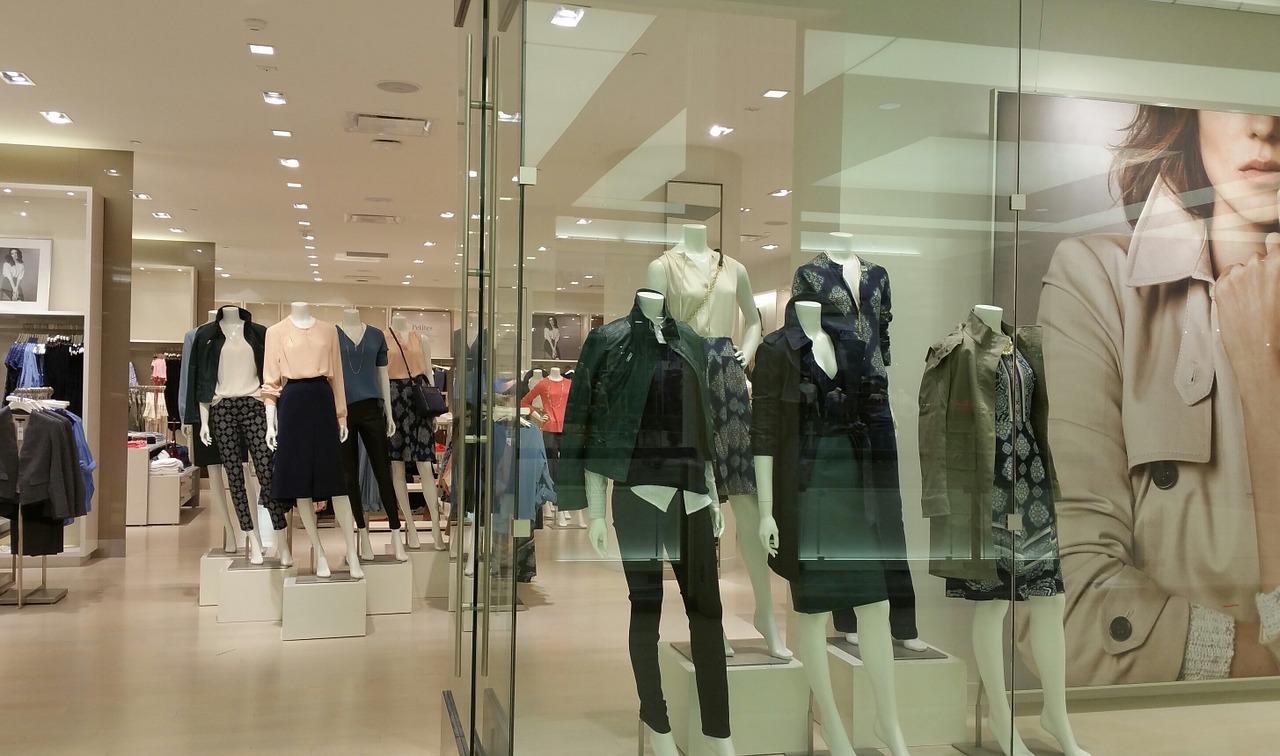Store display of women's fashion with mannequins.