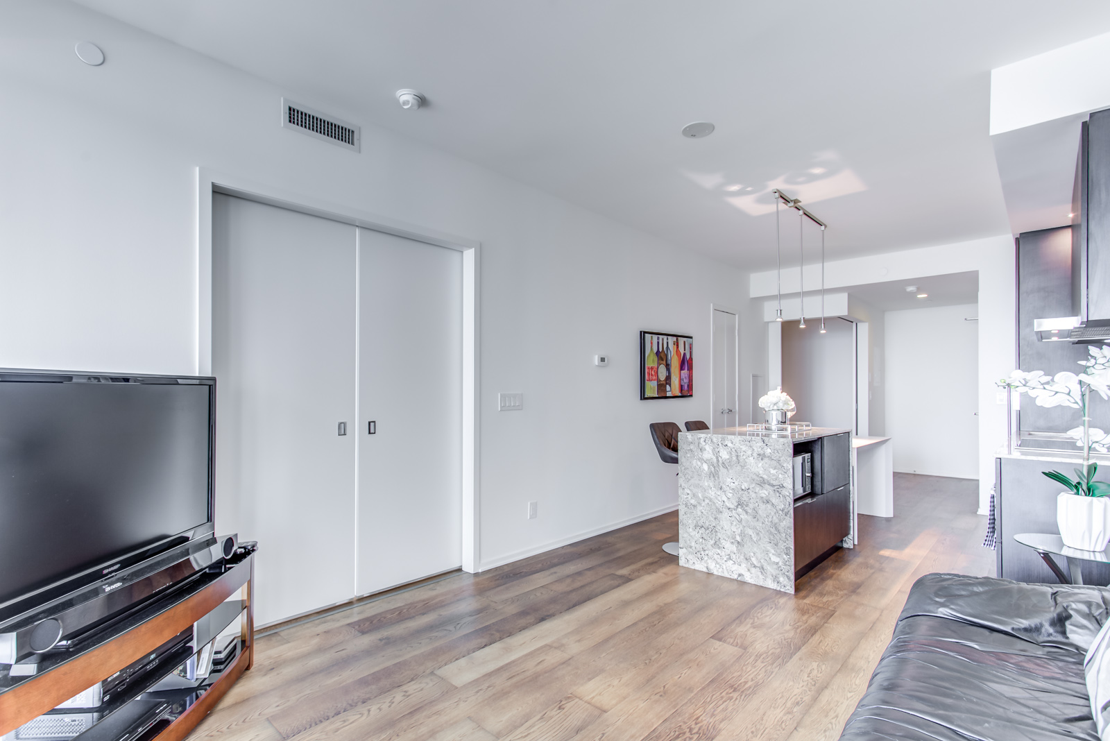 1 Bloor St E Unit 3408 interior photo of kitchen, bedroom, living and dining room.