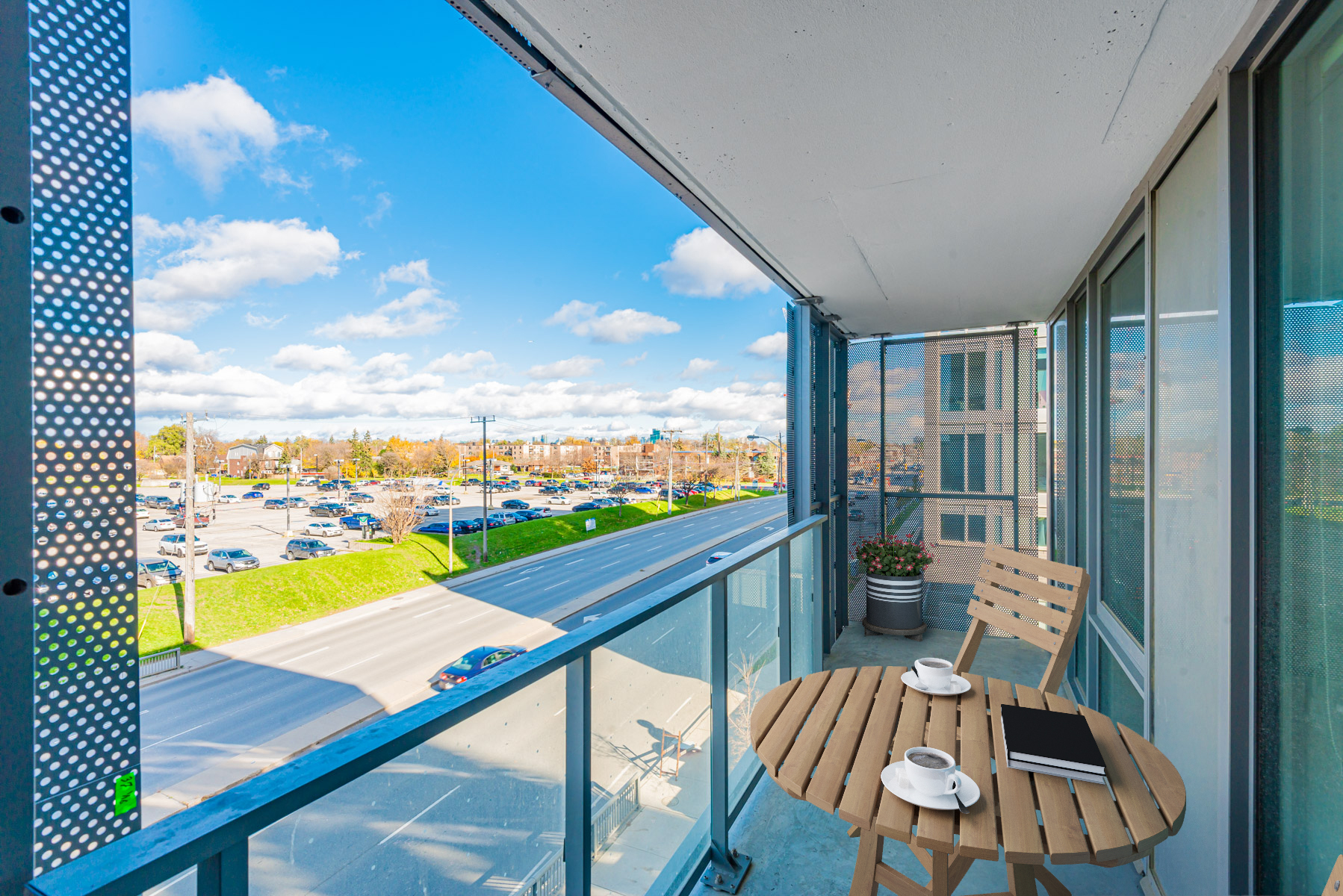 Condo balcony with glass panels and iron grating.