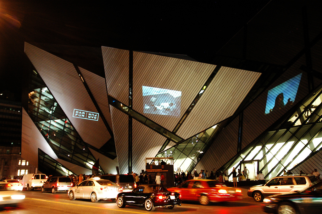 Night shot of the Royal Ontario Museum and, first of all, also, another, furthermore, finally, in addition because, so, due to, while, since, therefore