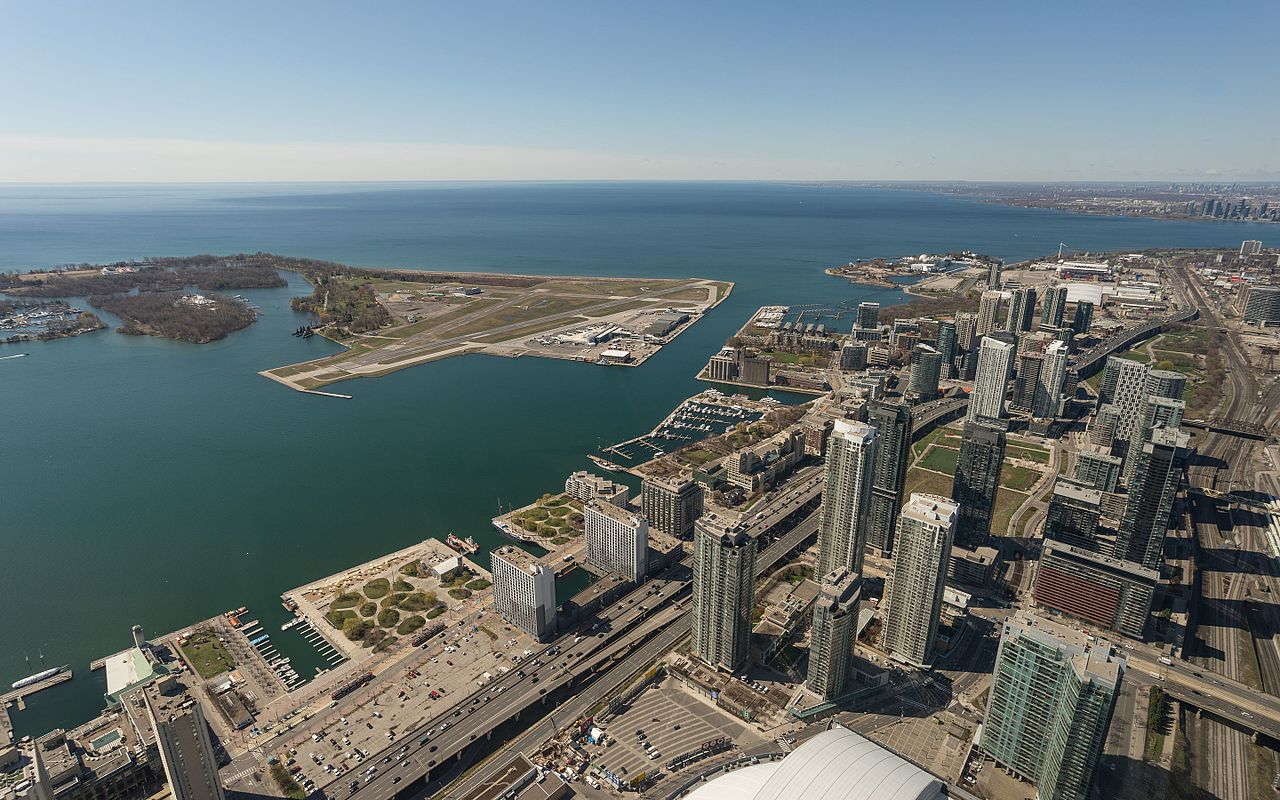 Sky view of Toronto's Waterfront showing streets, boats, and toronto real estate agent buildings.