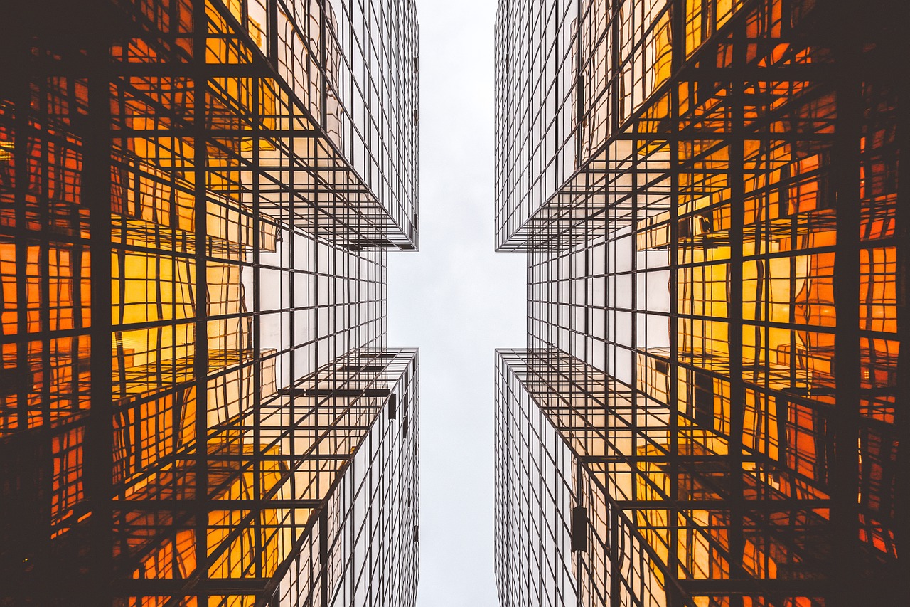 Two buildings close to one another; shows hot housing market.