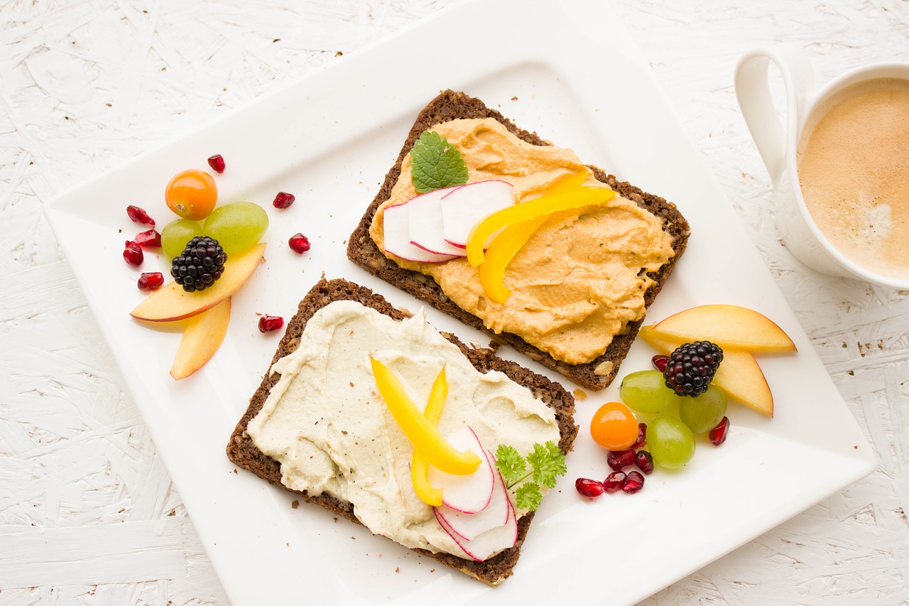 Vegan food including toast and fruits and vegetables.