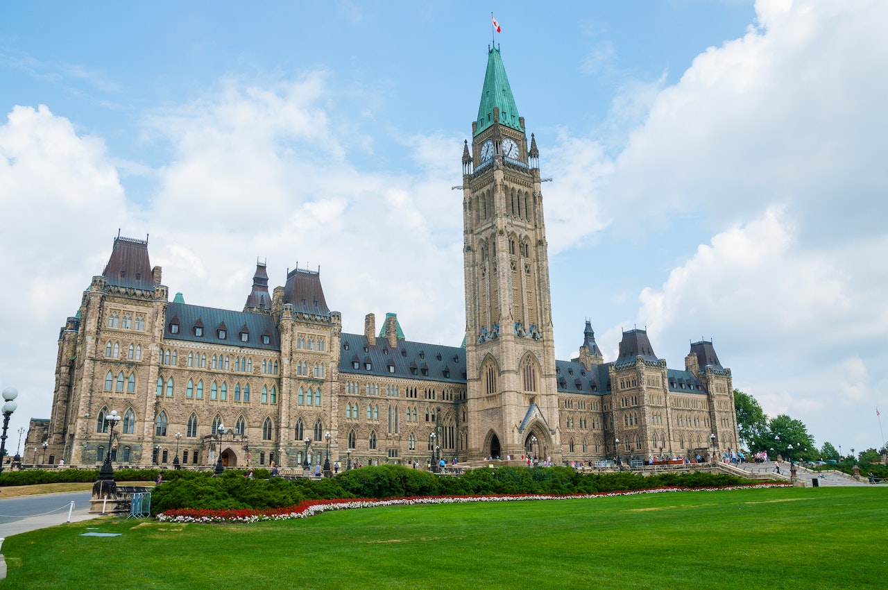 Canadian parliament building in Ottawa seen from lawn.