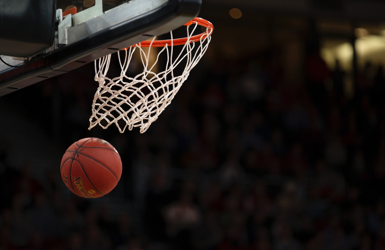 close up basketball going through hoop