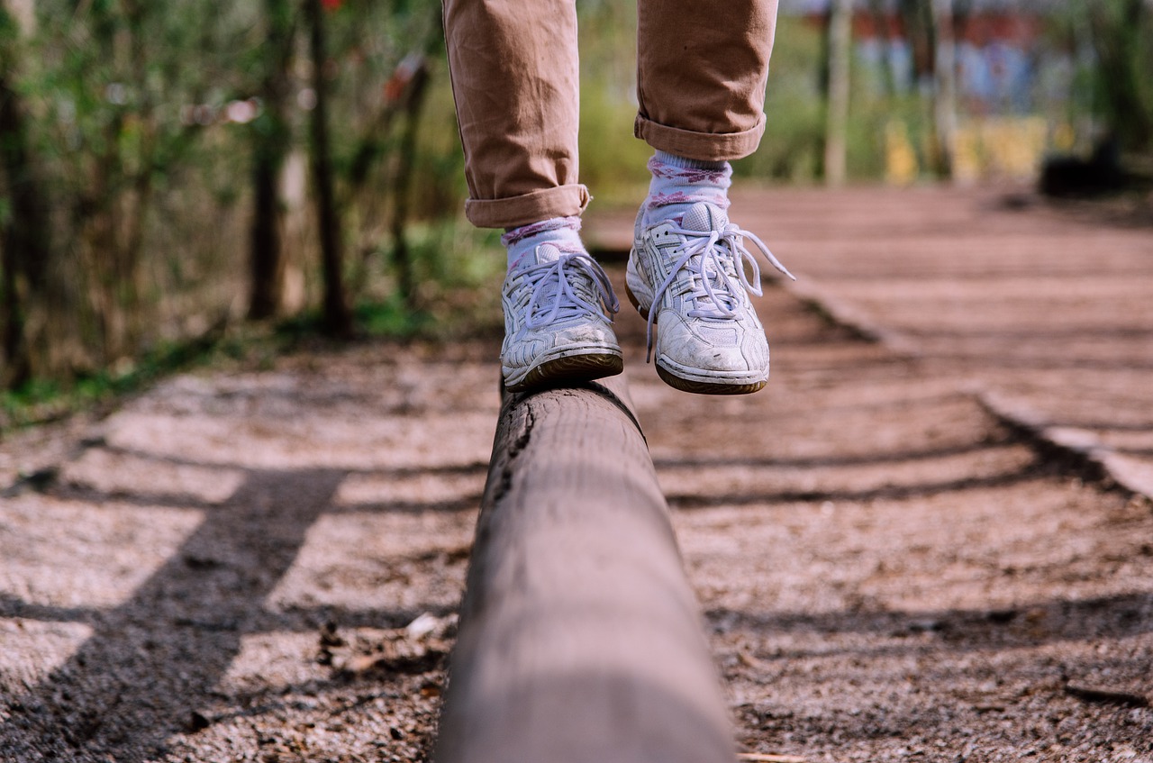 Close up of foot on log showing balanced housing market for March 2022.