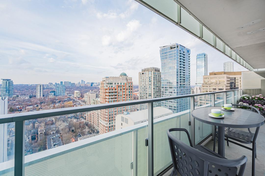 Condo balcony with patio table and chairs.