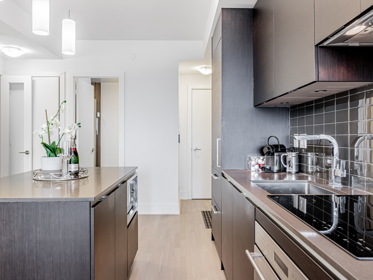 Condo kitchen with dark cabinets.