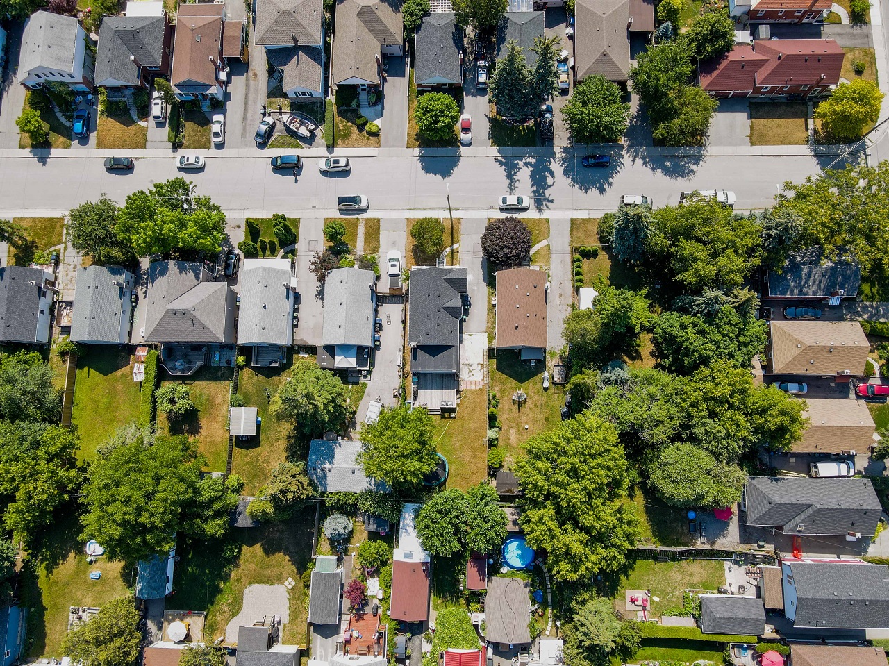 Ariel drone view of rooftops of suburban houses.