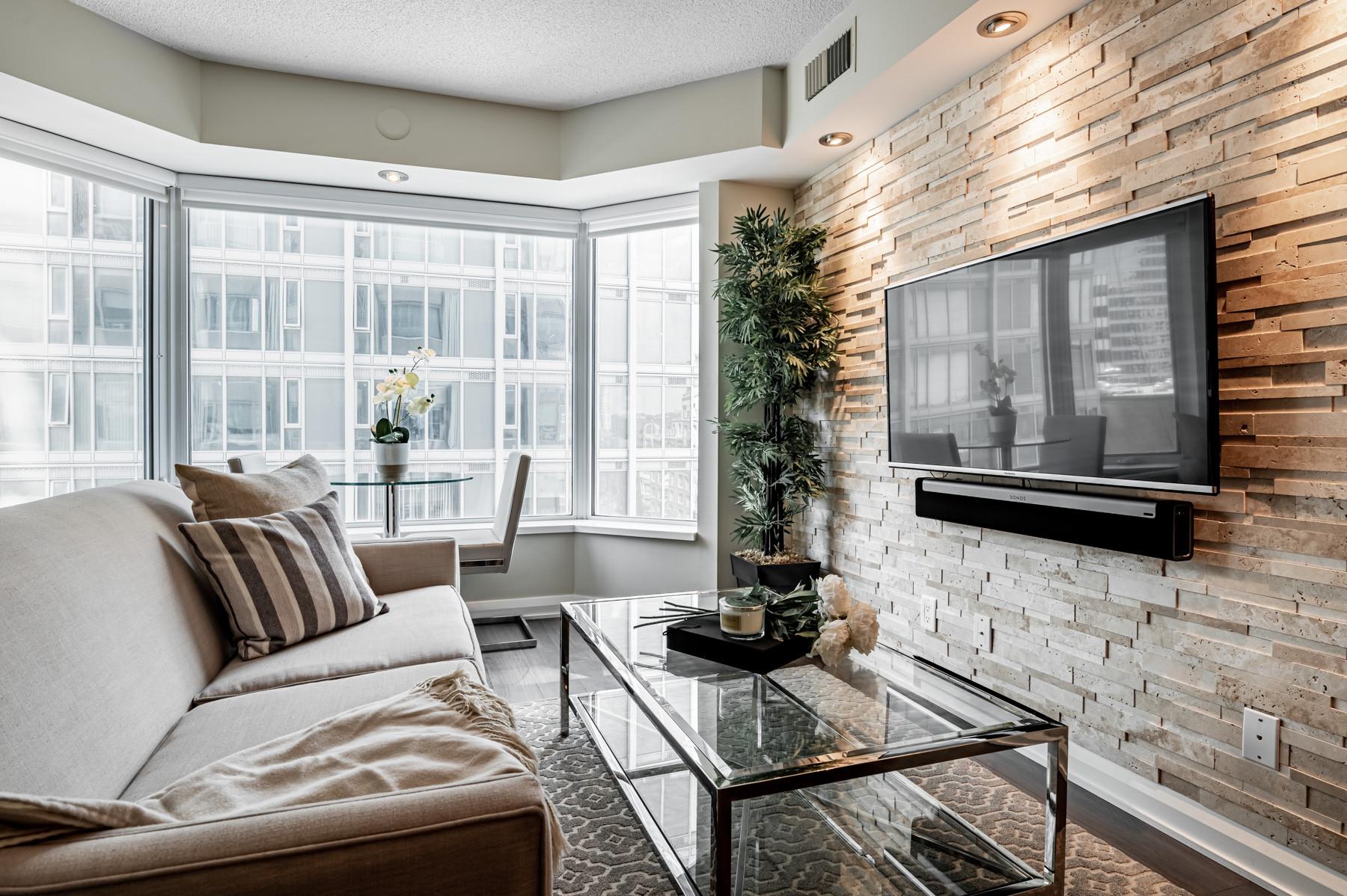 Wall-mounted TV and Sonos sound system.