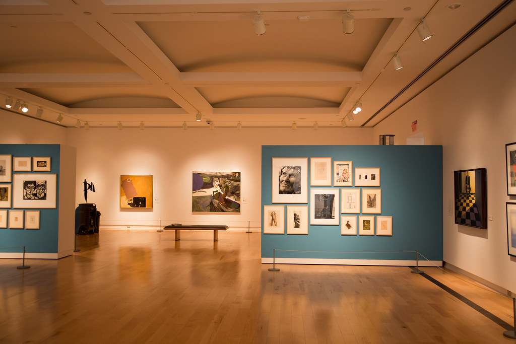 Empty art gallery with paintings and photos.