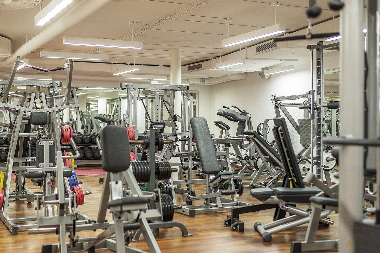 Gym equipment including weights and treadmills.