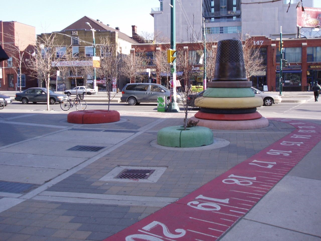 Giant thimble and red tape measure in the Fashion District.