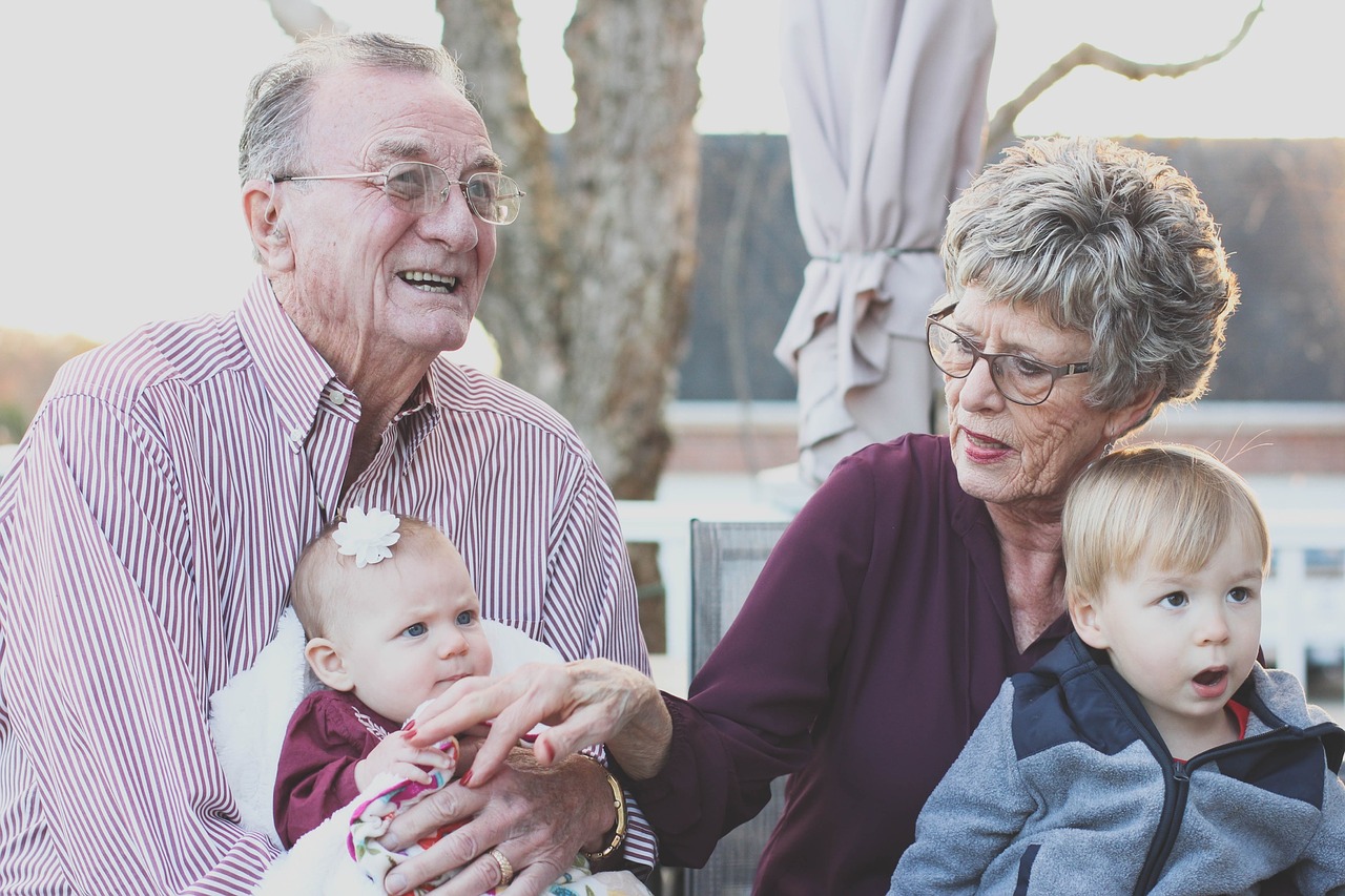 Image of elderly couple with children and MLS.