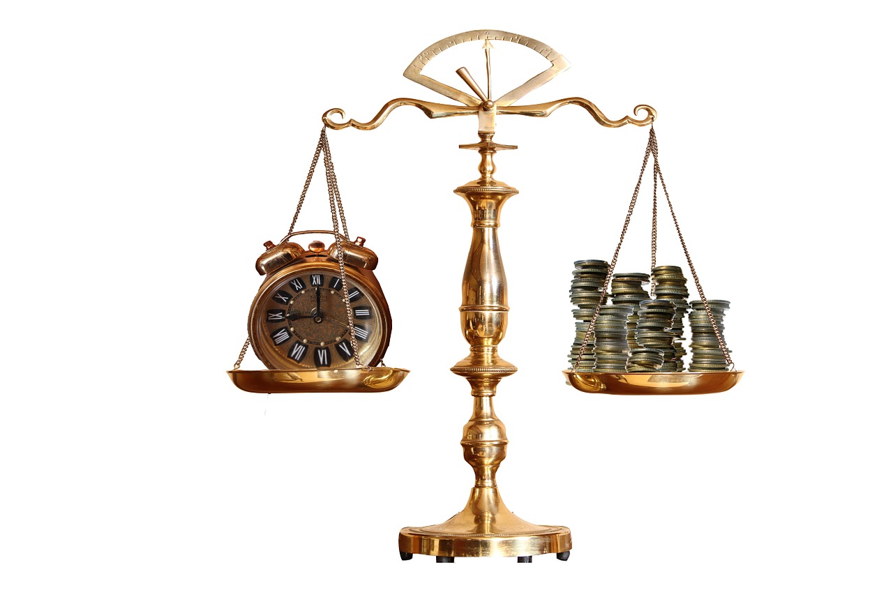 Pic of scales showing clock and money.