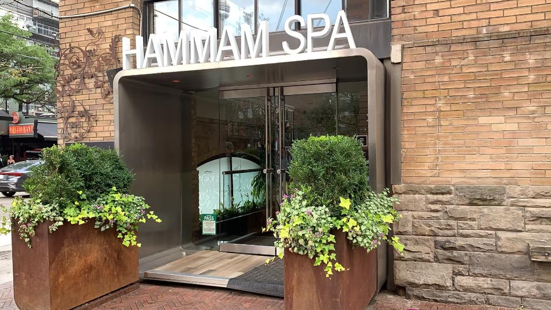 king west toronto hammam spa white sign brick exterior.