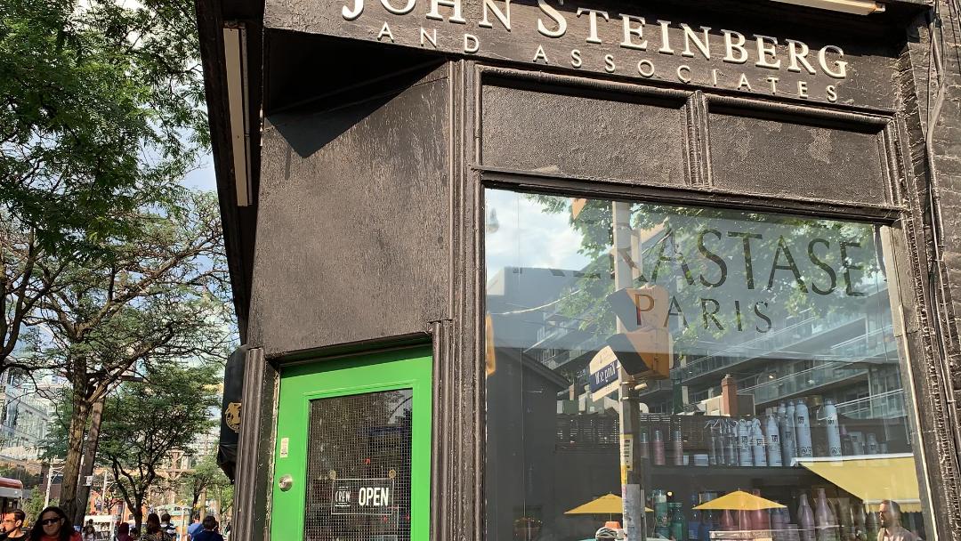 Brick exterior of John Steinberg & Associates hair salon on King West, Toronto.