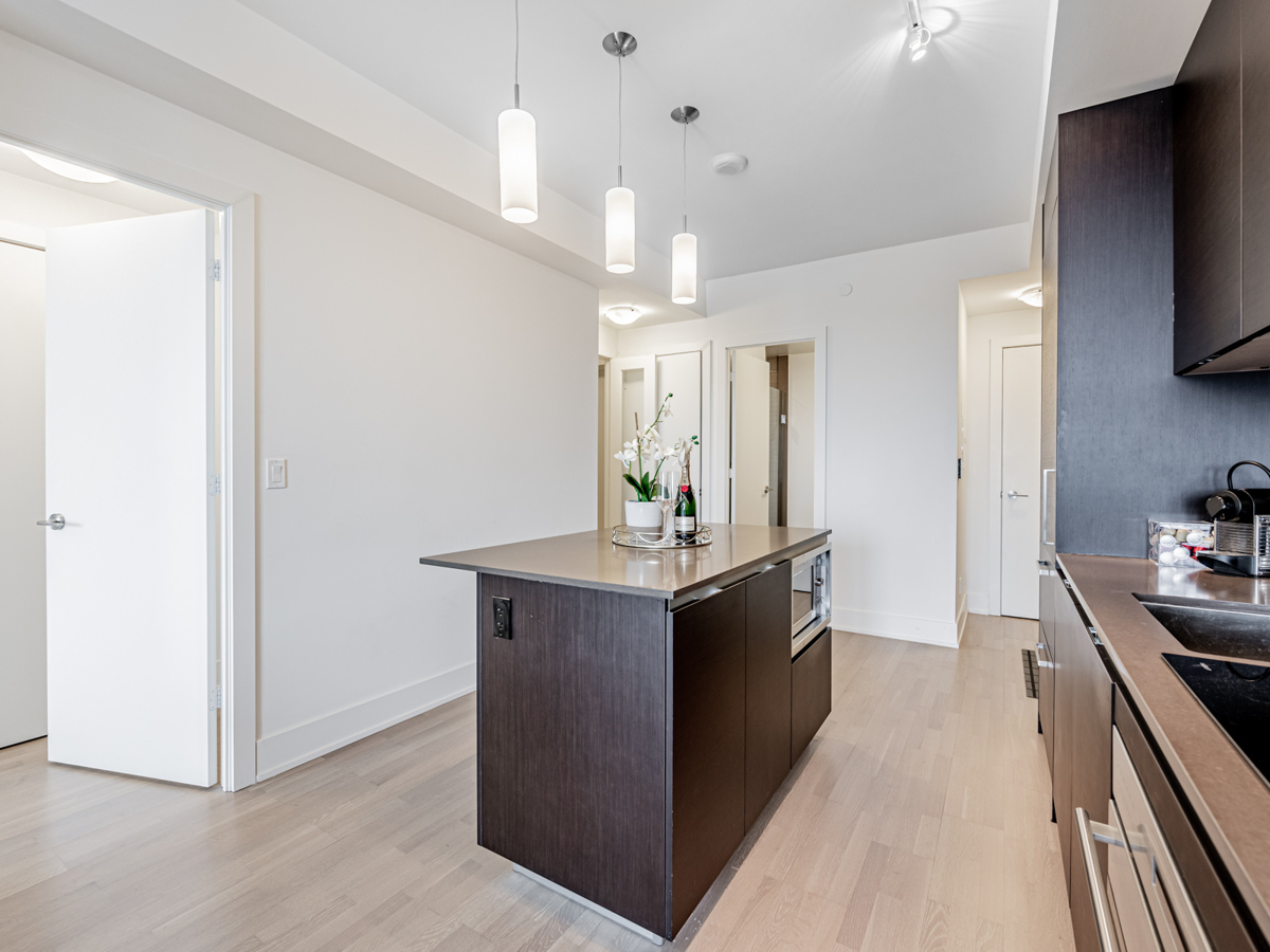 Quartz island with outlets and storage cabinets.