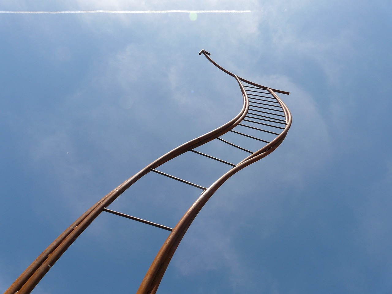 Tall twisting ladder showing rising interest rates in 2023.