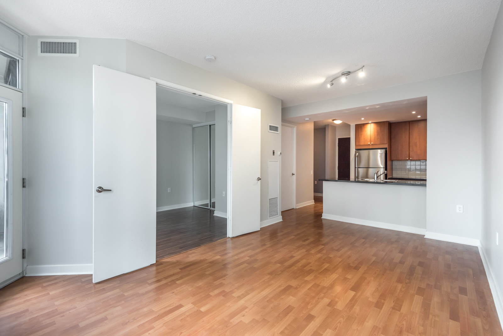 Picture shows kitchen, living room, and bedroom.