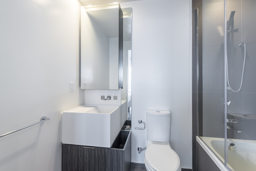 Photo showing the condo's 2nd bathroom with vanity & tub