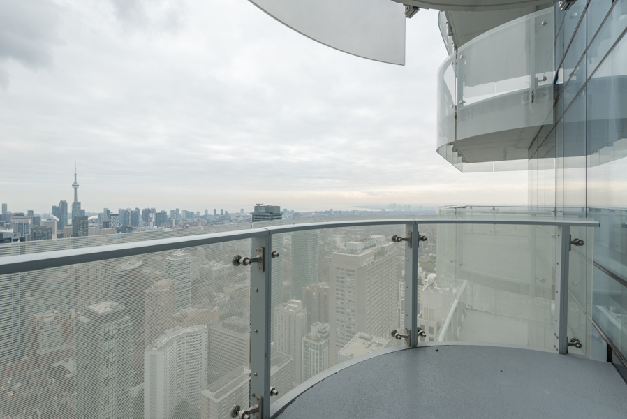 This image shows the condo's wrap-around balcony and view of downtown Toronto