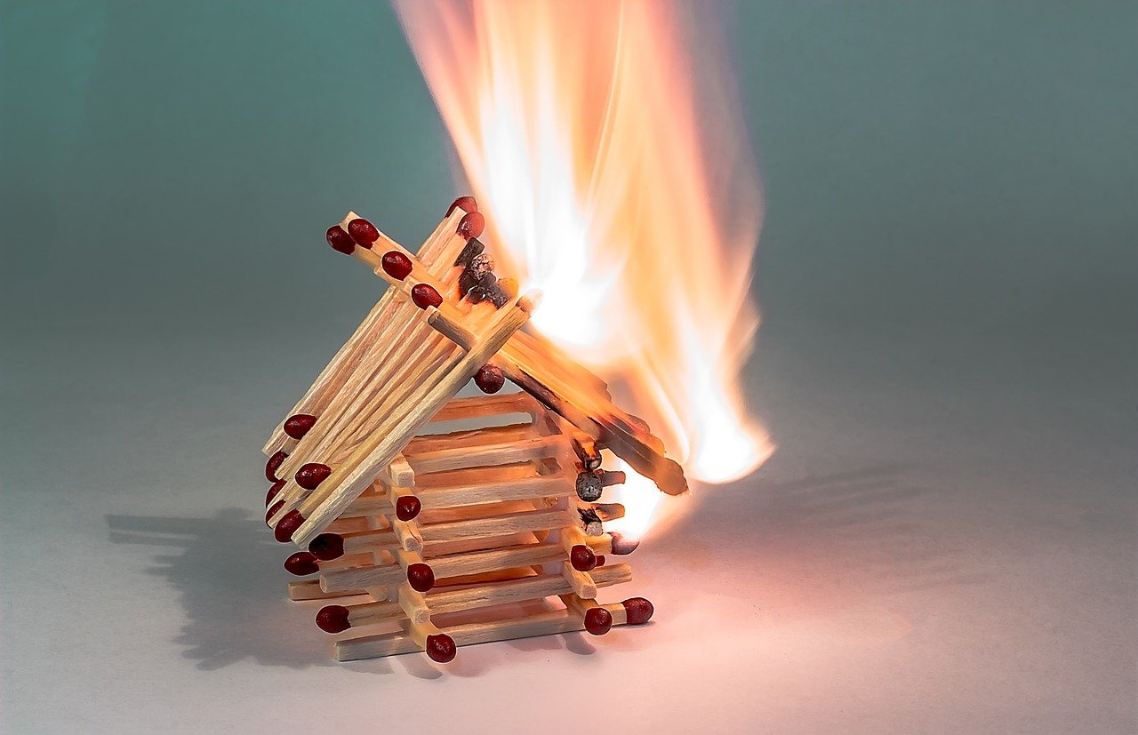 Matchstick house on fire showing heated March 2021 housing market.