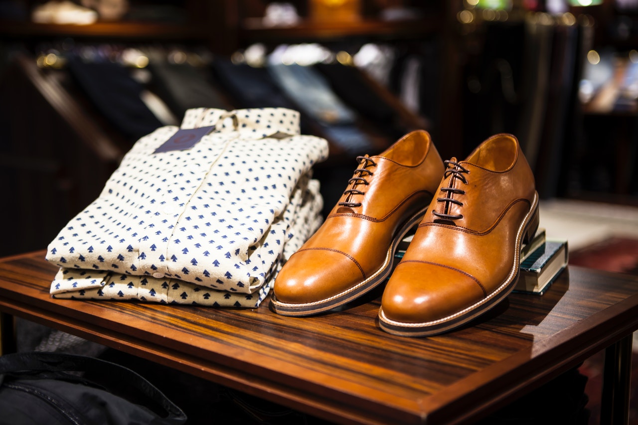 Man's short and brown leather shoes on display at store.