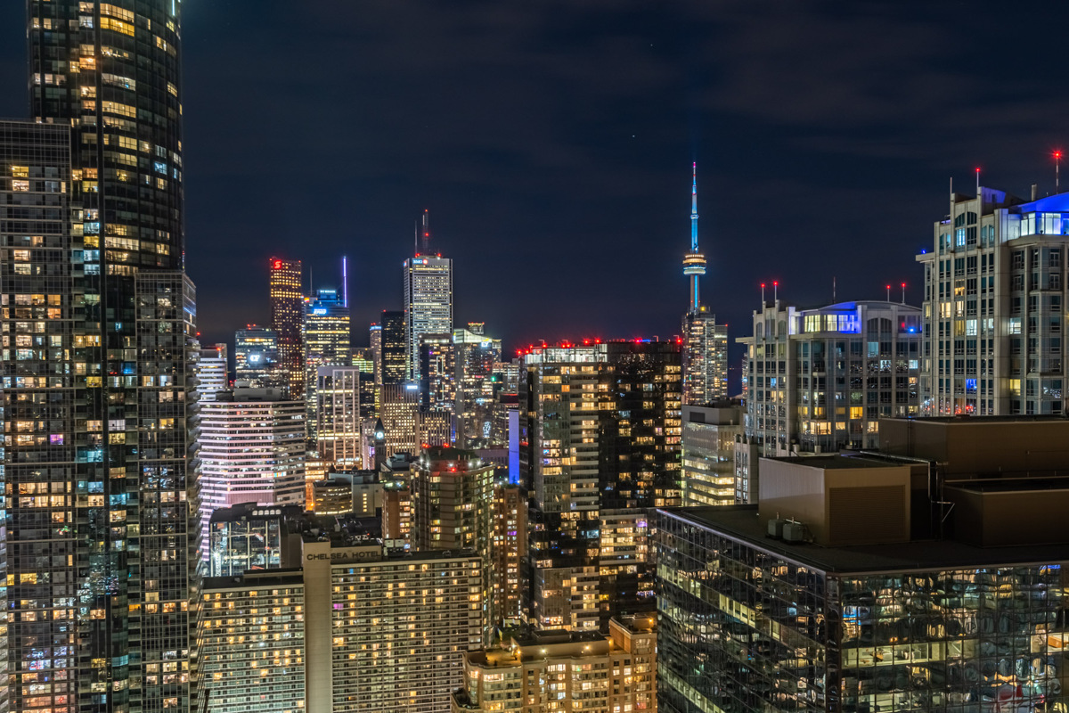 Brightly lit Toronto skyline at night and CN Tower.