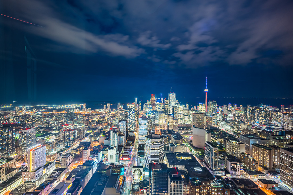 Brightly lit Toronto skyline at night as seen from 388 Yonge St PH 7907.