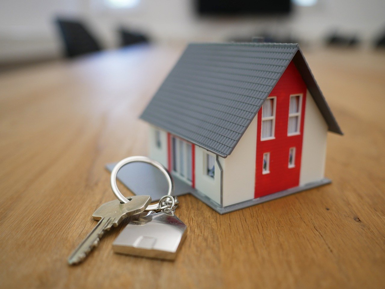 Table with model house and key.