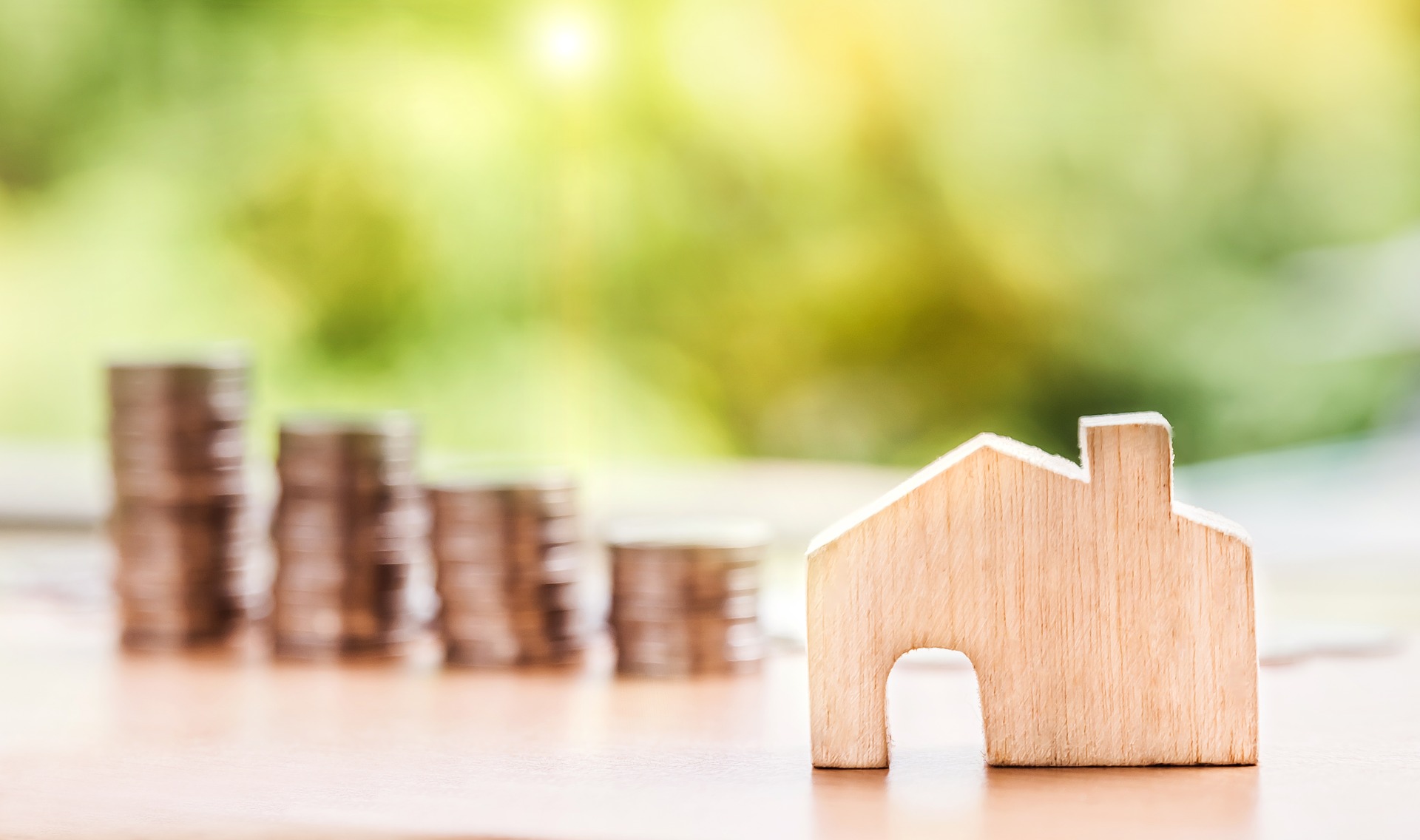 Image of house in front and coins in back