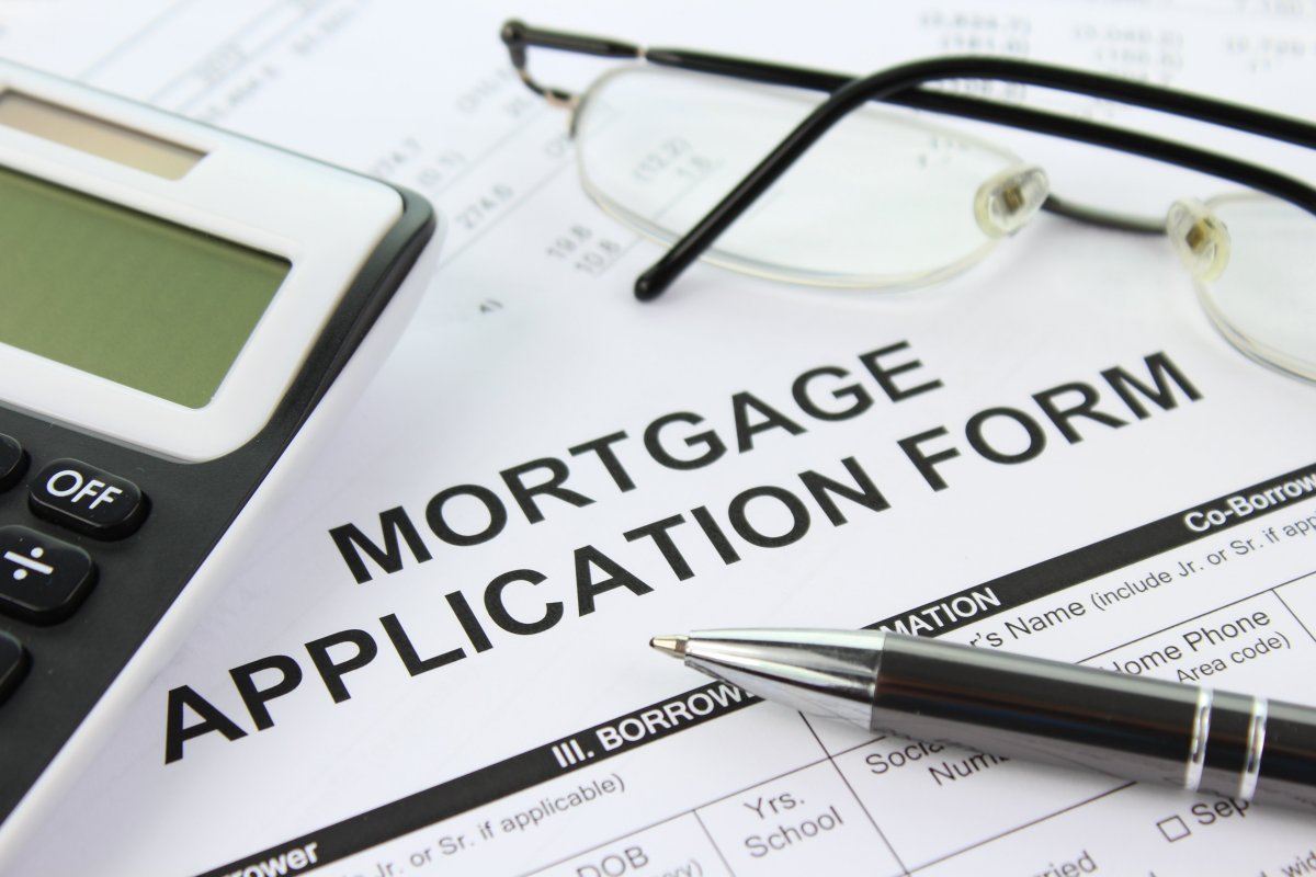 Photo of a mortgage application form for a fixed rate mortgage and also a pen and glasses.