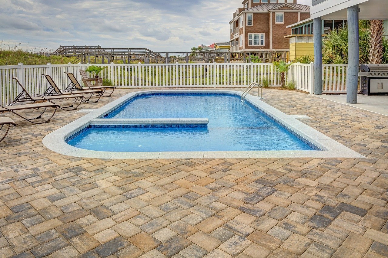 Outdoor swimming pool in backyard.