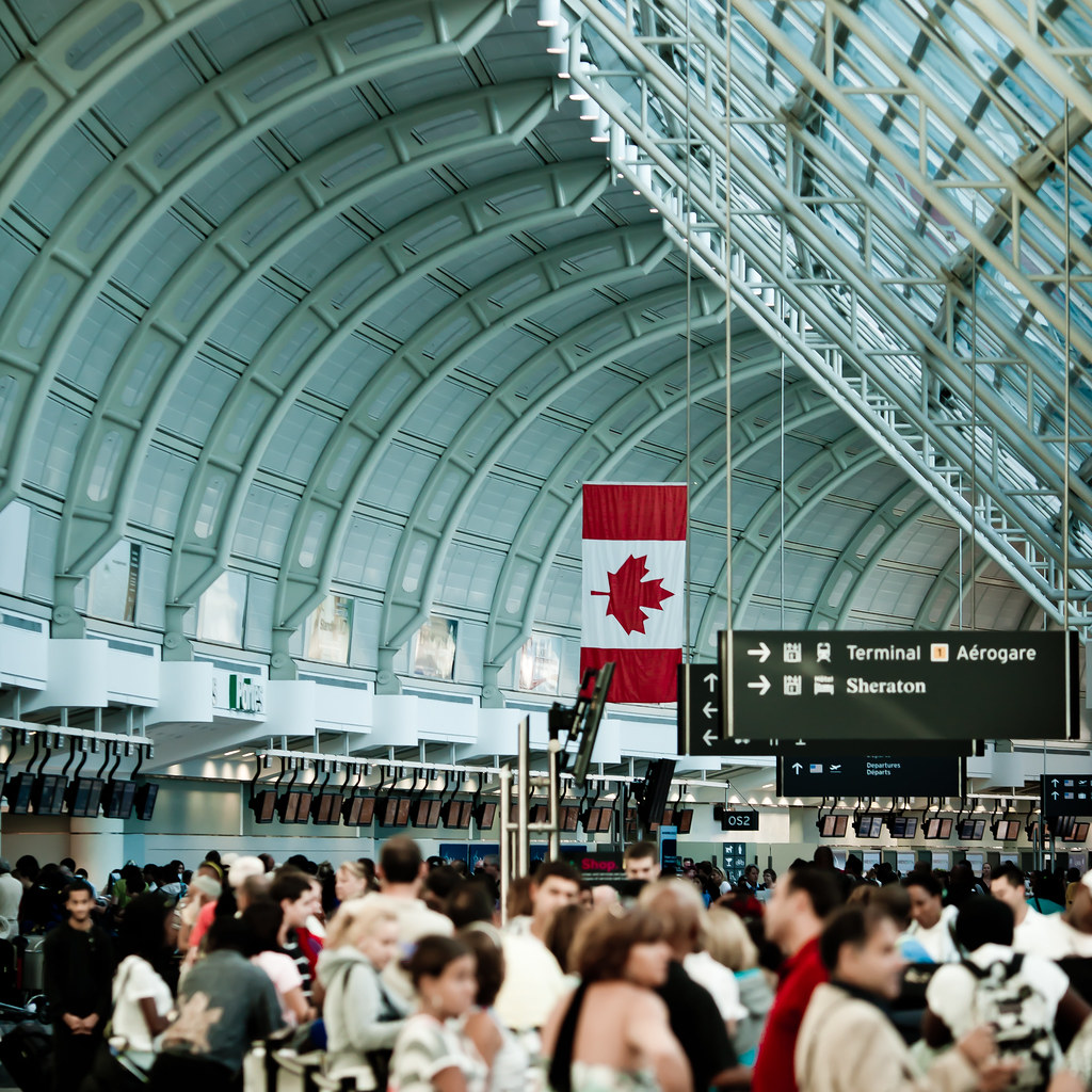 Pearson International Airport terminal with large Canadian flag. 