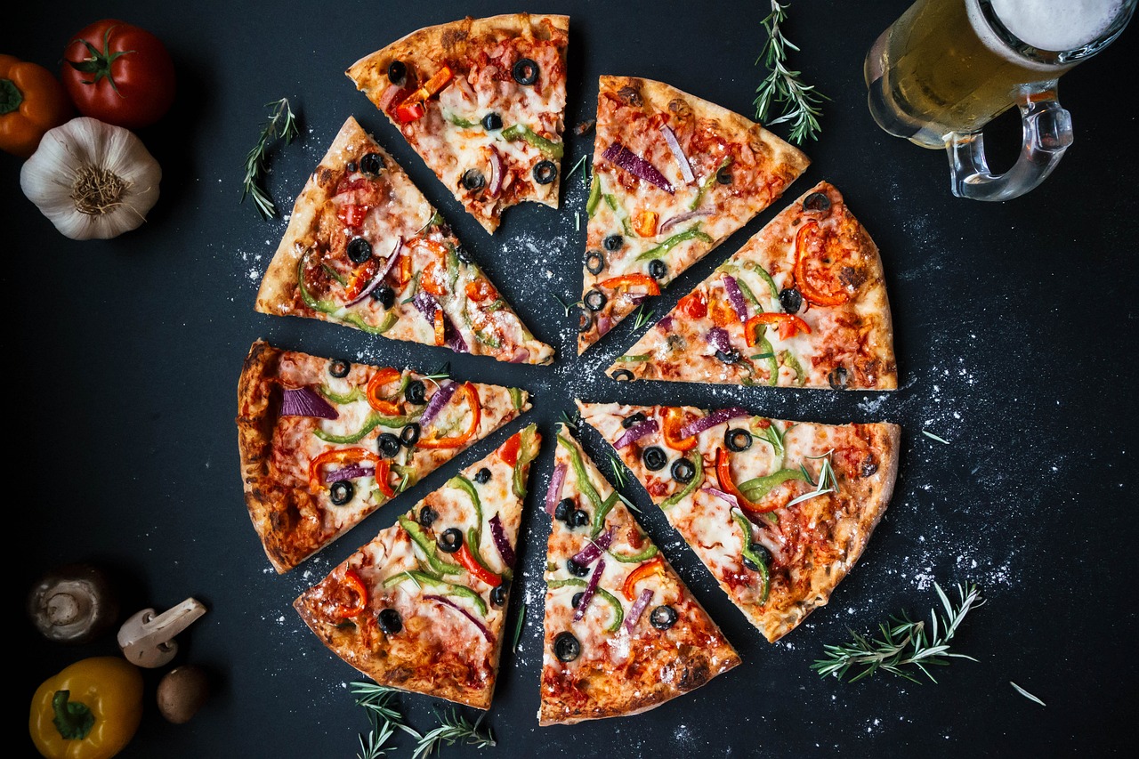 Picture of pizza cut into slices; it looks rather delicious.