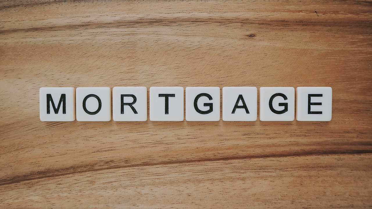 Scrabble tiles spelling word "MORTGAGE."