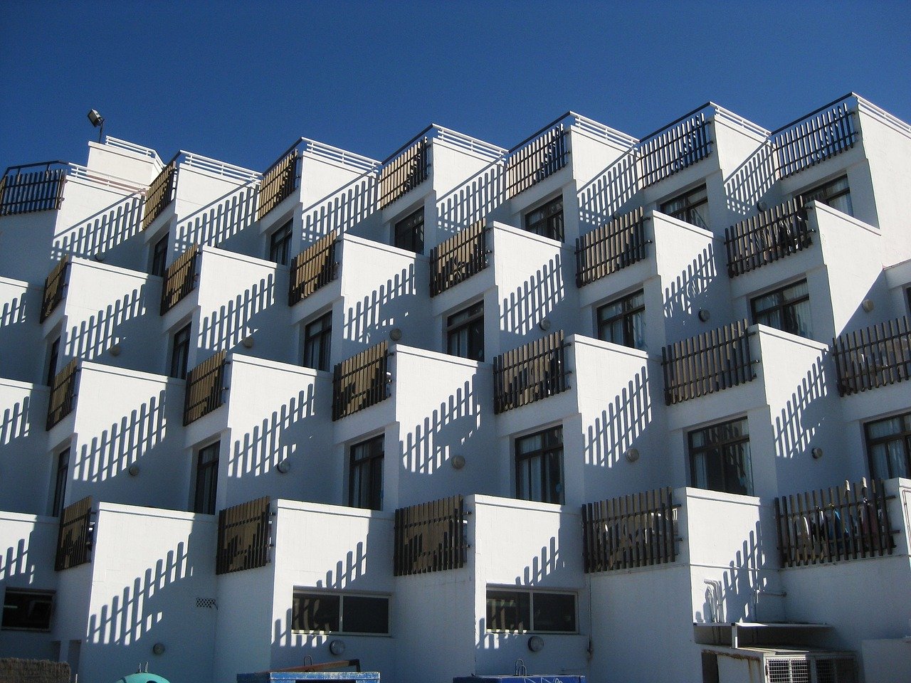 Tiny stacked apartments showing Simply Home Downsizing challenge of decorating micro condos.