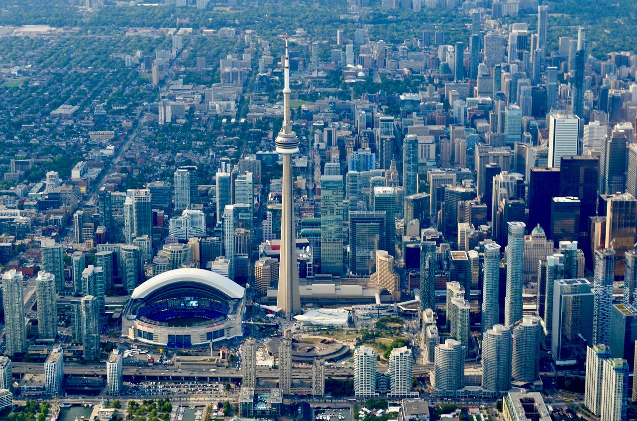 Toronto skyline and buildings showing impact of permanent residency programs.