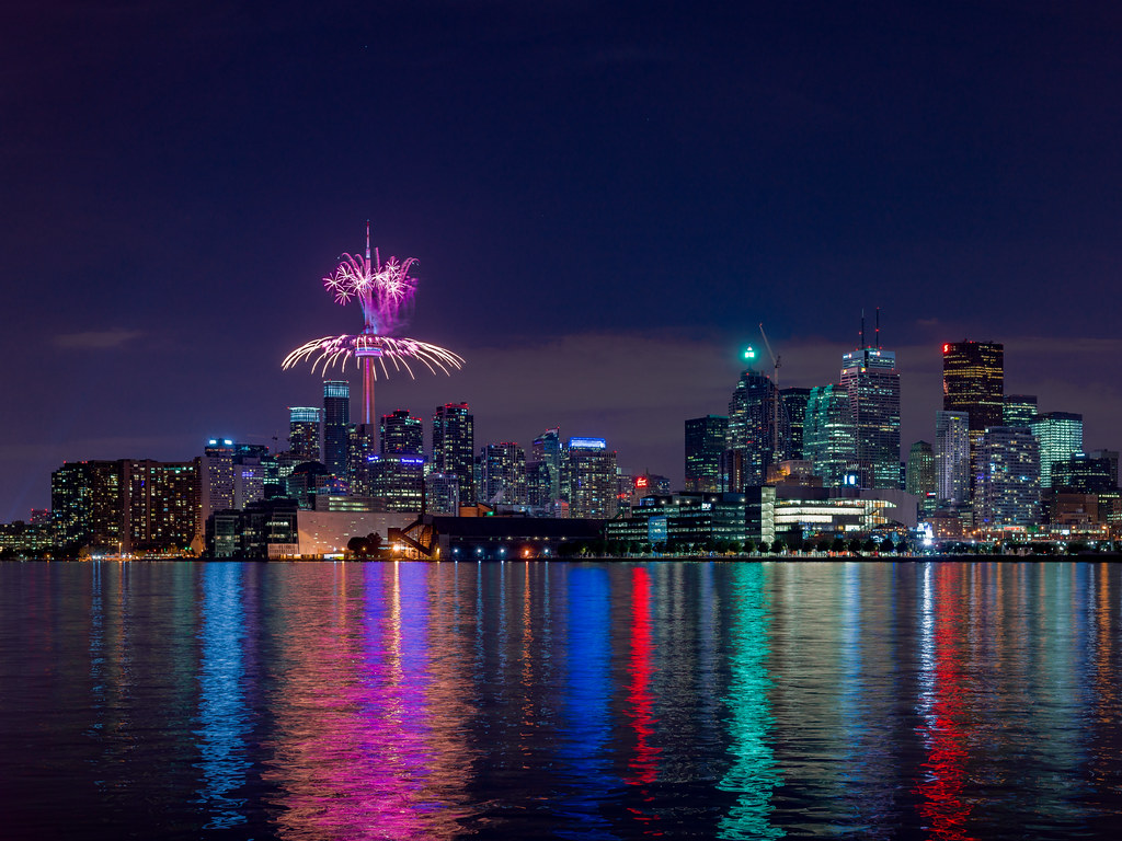 Toronto skyline new year celebrations with fireworks around CN Tower.