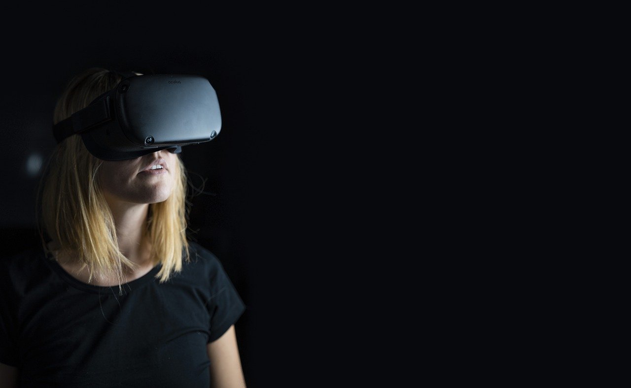 Young woman wearing virtual reality headset to show virtual tours during COVID-19.