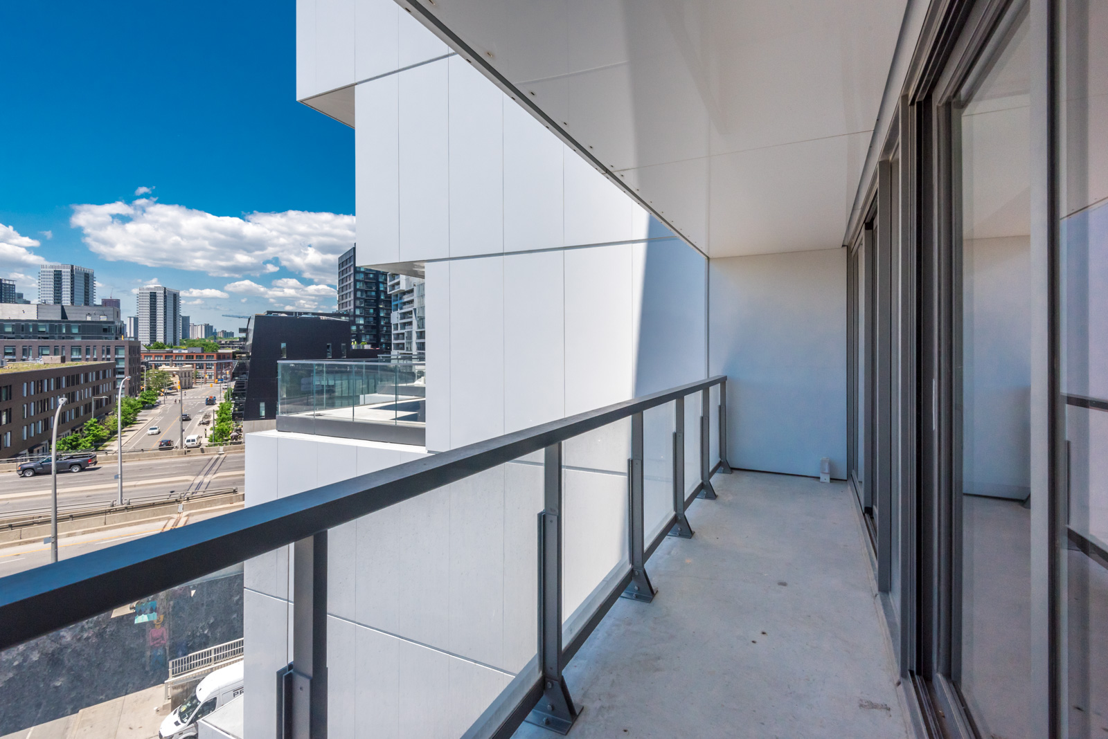 Here we see the balcony and view of streets. It's very wide and also has glass rails.