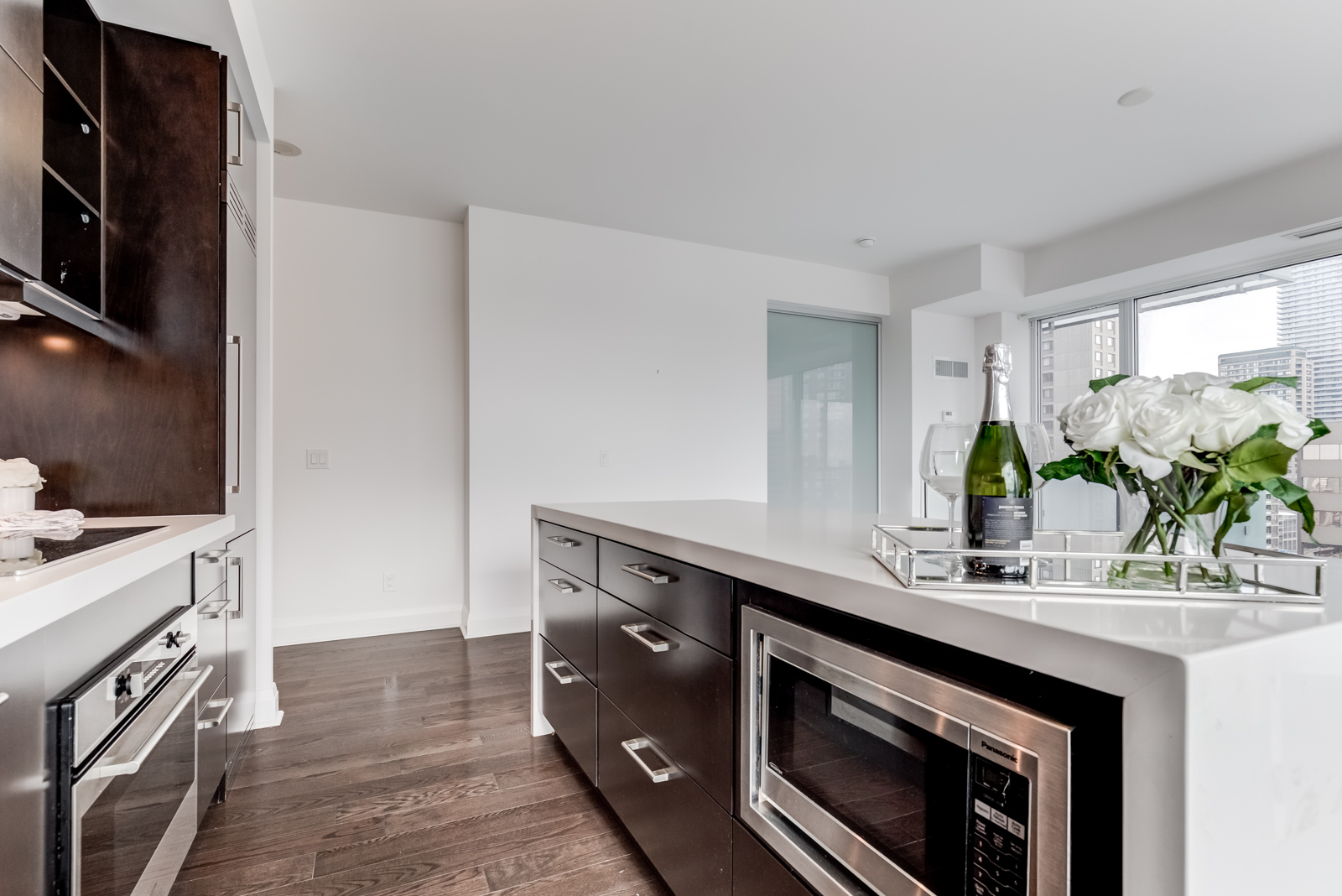 Kitchen from another angle; shows microwave and kitchen island.