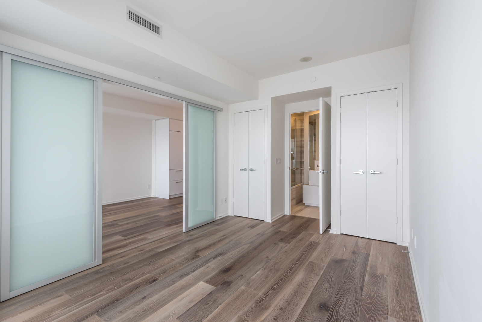 Photo shows master bedroom, bathroom, and closets.