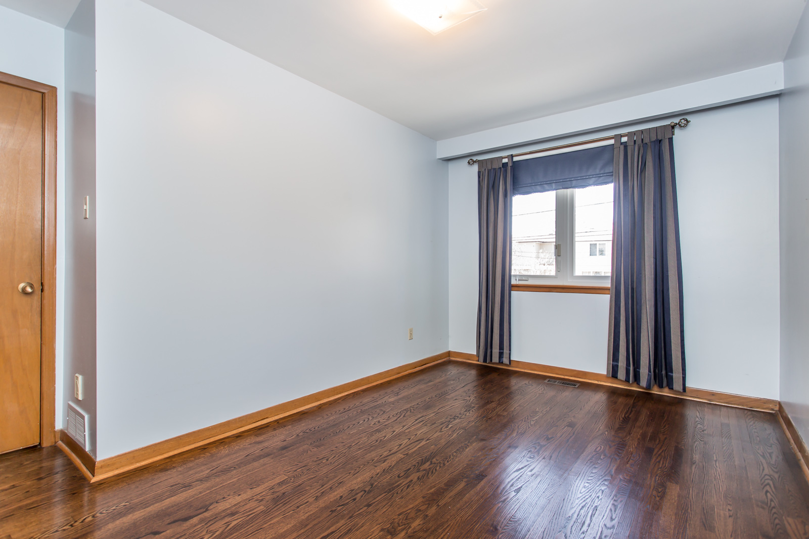 Much as the master bedroom, this one has rather dark floors, and the walls are less light.